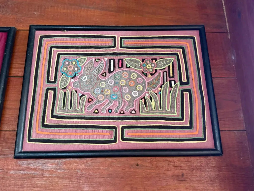 A framed piece of Mola art, panels of layered embroidery unique to the Guna Yala people.