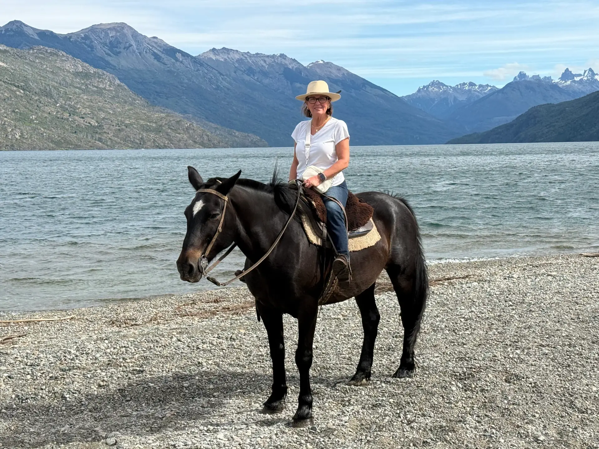 Anne Marie on Lucero, a large black horse with a white star on his forehead. Posing on the shores of Lago Puelo, a lake situated in Argentina's Patagonia Region, the new Old West.
