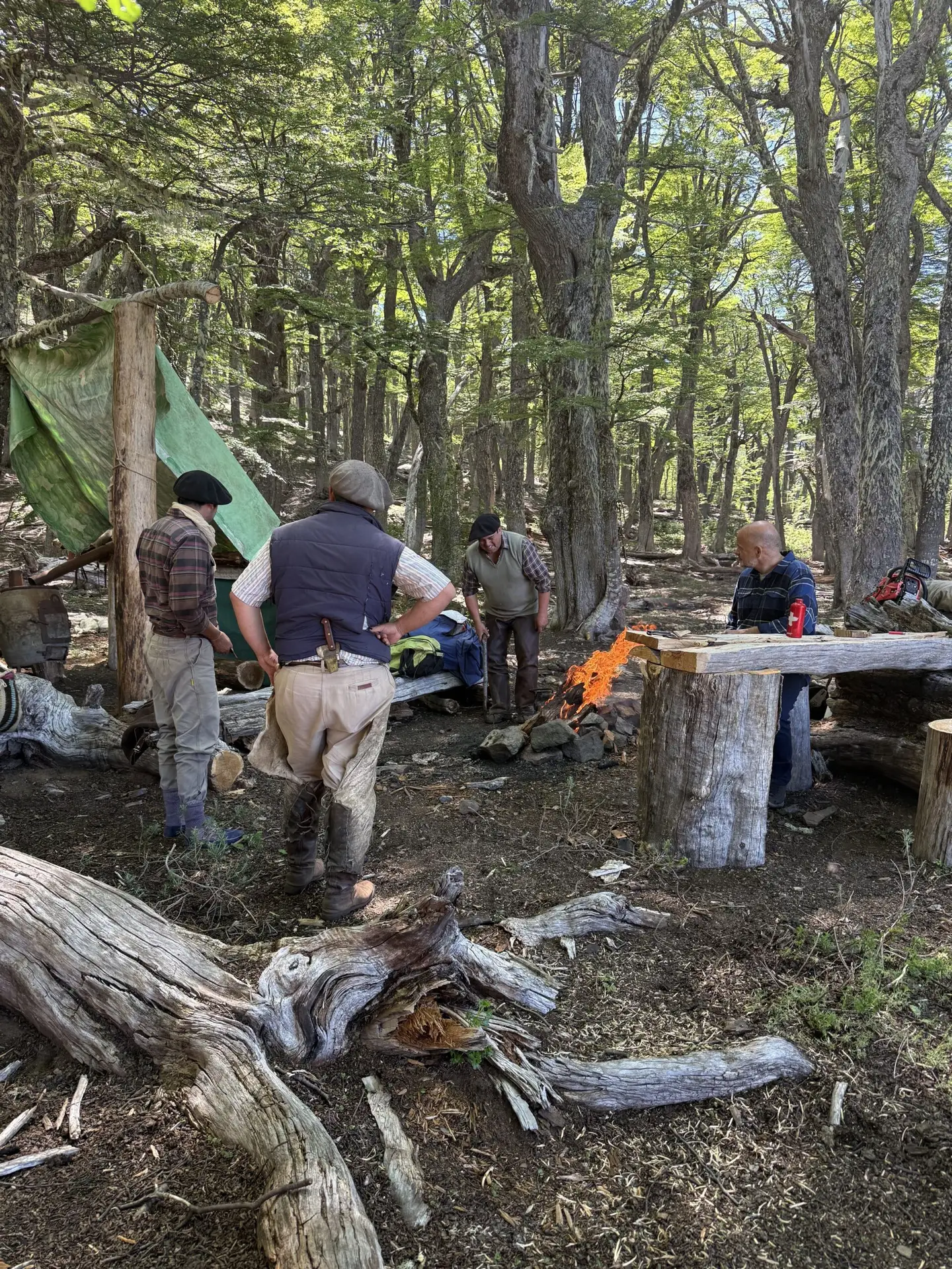 Trip guides are setting up camp, getting a fire started.