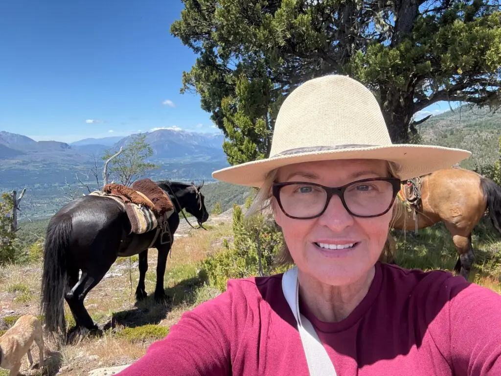 The author standing at a resting stop on the mountain, a ridge overlooking the El Bolson valley