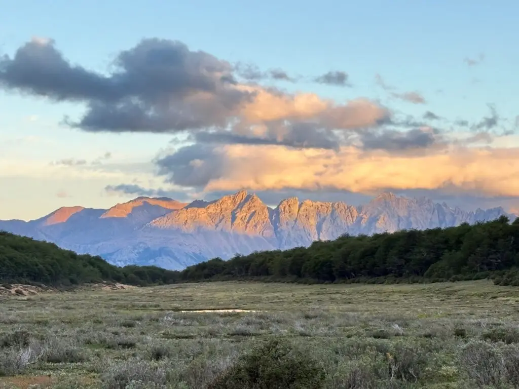 Setting sun reflecting off the mountains in front of the camp.